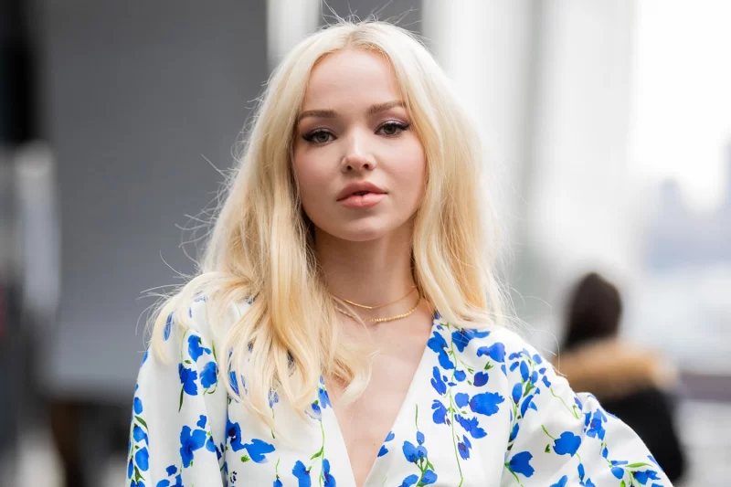 Dove Cameron surgery Dove Cameron posing on the street with a white and blue blouse and blond hair