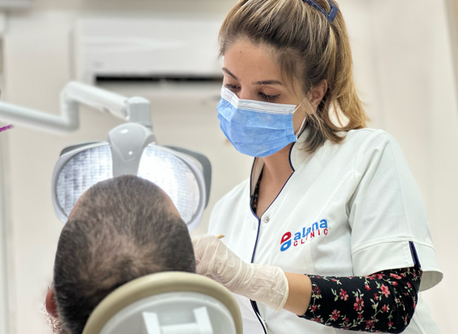 MCAN Health Dentist while applying Dental Treatment