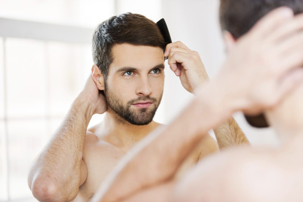 man using a hair growth oil 
